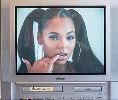 an old television with the image of a woman on it