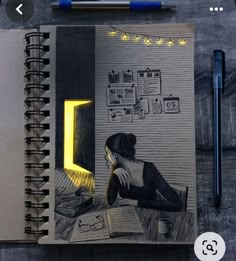 an open notebook with a drawing of a woman sitting at a desk