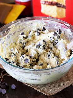 a bowl filled with cookies and cream on top of a table next to chocolate chips