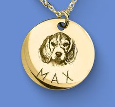 a dog's head is engraved on a gold plated necklace that says max