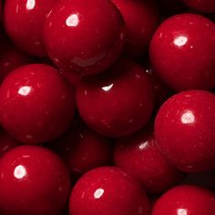 a pile of red candy balls sitting on top of each other