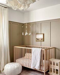 a baby's room with a crib, bed and toy in the corner