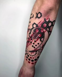 a man's arm with a black and red tattoo design on the left forearm