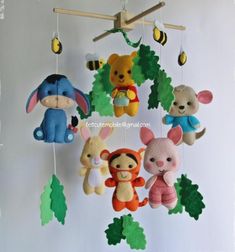 several stuffed animals are hanging from a mobile