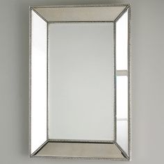 a large mirror hanging on the wall