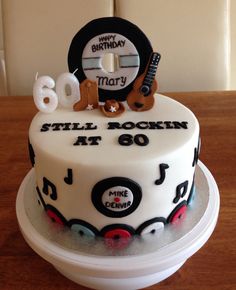 a birthday cake with the number 80 on it and musical instruments for someone's 80th birthday