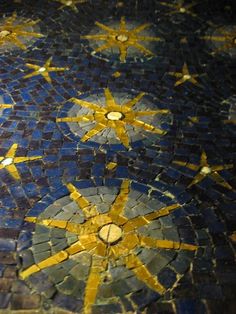 the floor is made up of blue and yellow tiles with gold stars on each side