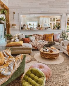 a living room filled with lots of couches and chairs next to a fire place