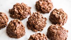 chocolate cookies are arranged on a white surface