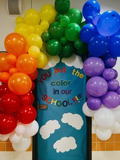 a door decorated with balloons and the words you put the color in our school's doors