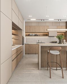 a kitchen with an island and stools in it