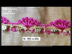 a pink and white crochet design on a piece of fabric with gold trim