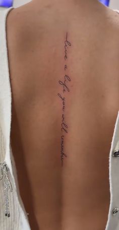 the back of a woman's neck with writing on it