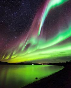 an aurora bore is seen over the water at night