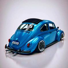 a blue vw bug sitting on top of a white floor