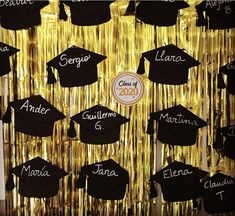 graduation caps and tassels are hanging on the wall in front of gold tinsel