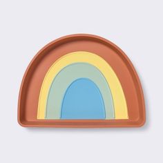 an orange plate with a rainbow design on it