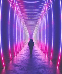 a person walking down a long tunnel with neon lights on the walls and ceilinging