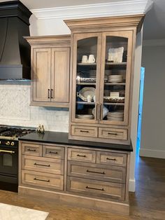 a kitchen with wooden cabinets and black appliances