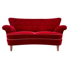 a red couch sitting on top of a white floor