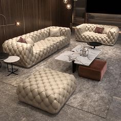 a living room filled with lots of furniture on top of a carpeted floor next to a wooden wall