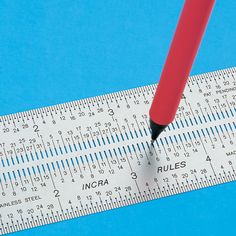 a ruler with a red pen on top of it