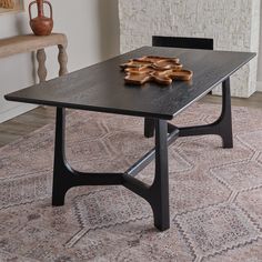 a table with some cookies on top of it in front of a chair and rug