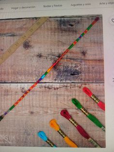 there are many crayons and pencils on the wooden table next to each other