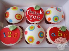 some cupcakes are in a box with the words thank you and apples on them