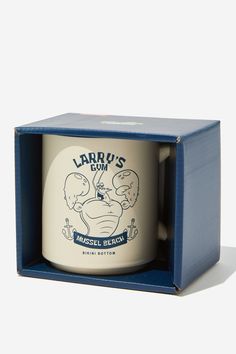 a coffee mug in a blue box with an image of a cartoon character on it