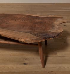 a wooden table sitting on top of a hard wood floor