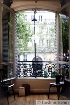 two chairs sitting in front of an open window