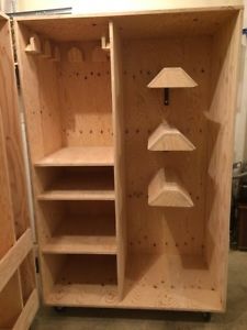 an unfinished wooden cabinet with shelves and lamps