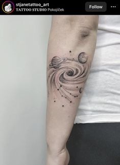 a woman's arm with saturn tattoo on it