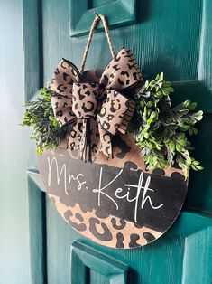 a leopard print door hanger with the name mrs ketth hanging on it