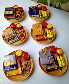 four wooden plates with different designs on them