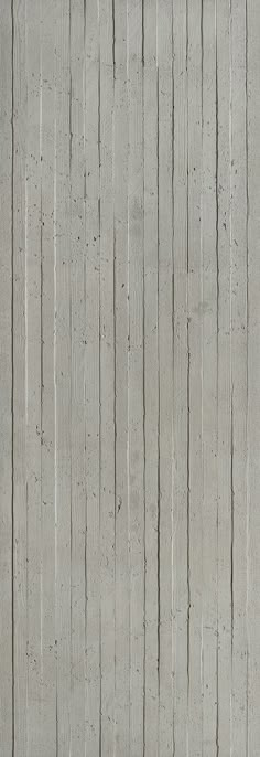 a person sitting on a bench in front of a wall with vertical lines painted on it