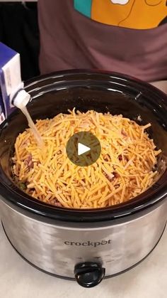 the crock pot is full of shredded cheese