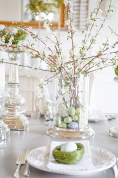 an easter table setting with eggs and flowers