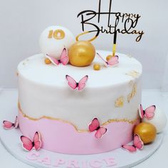 a birthday cake decorated with pink and gold butterflies