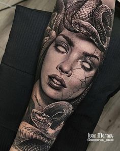 a woman with a snake on her arm and head is depicted in this tattoo design