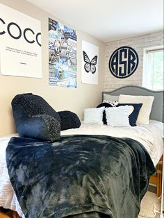 a bed with blue and white pillows in a bedroom