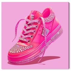 a pink sneaker with lots of diamonds on the top and bottom, against a pink background