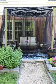 an outdoor living area with furniture and flowers