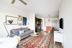 a living room filled with furniture and a flat screen tv