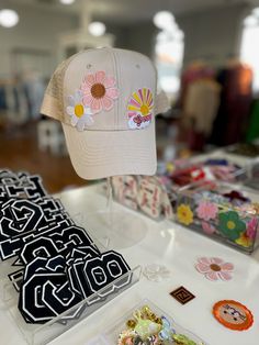 Score a custom hat for $39! The hat color and patches will be a total mystery! We have a variety of hat colors including black, white, red, yellow, orange, blue, green, pink, and more. Our patches could be your initial, athletics, boho, western, flowers, travel, etc. All hats are adult size and will include 3 patches. ALL SALES ARE FINAL. Are you ready for the mystery? Below are some examples of hats made in store. Want to make your own? Visit us in store for the Hat Making Experience! Retro Snapback Hat With Curved Bill For Spring, Spring Snapback Baseball Cap With Logo Patch, Spring Logo Patch Snapback Baseball Cap, Casual Pink Hats With Logo Patch, Flat Brim Hats With Logo Patch For Spring, Vintage Curved Bill Snapback Hat For Spring, Retro Curved Bill Hats For Spring, Spring Baseball Cap With Logo Patch And Curved Brim, One Size Snapback Hats With Patches