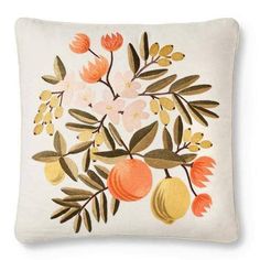 an embroidered pillow with flowers and fruit on it