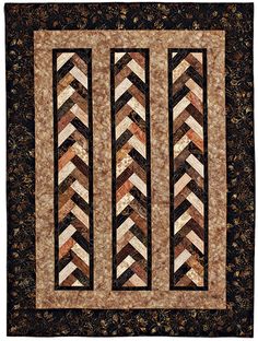 a quilted wall hanging with three different designs on it's sides and one is brown