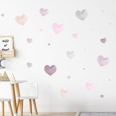 a room with hearts painted on the wall and a table in front of it,