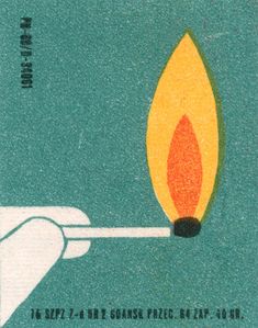 a matchstick with a lit match in it being held by a person's hand